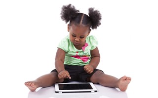 Little african american girl using a tablet pc